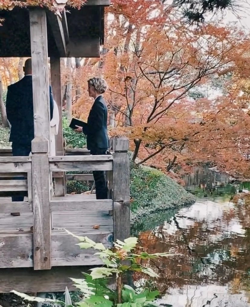 Chelsie officiating an intimate outdoor ceremony in a garden