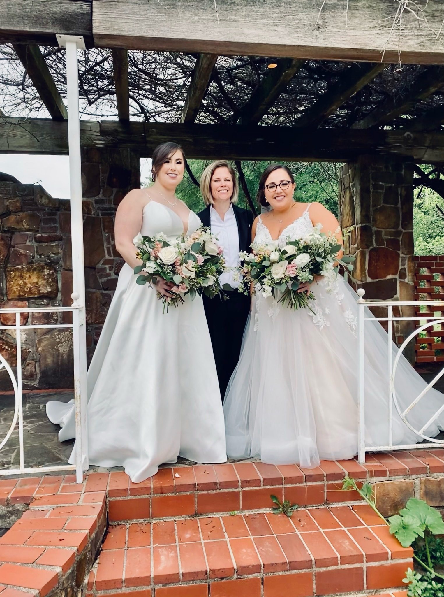 Chelsie celebrating with two brides after their wedding ceremony