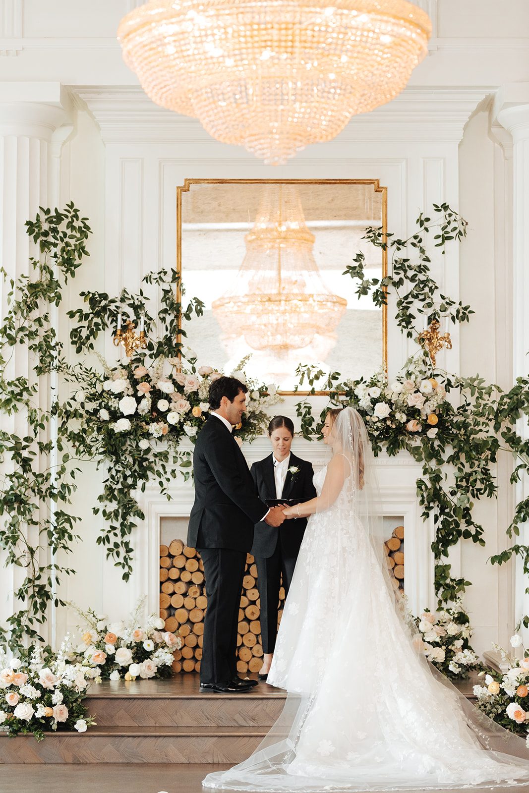 Chelsie officiating a wedding ceremony in an elegant floral setting